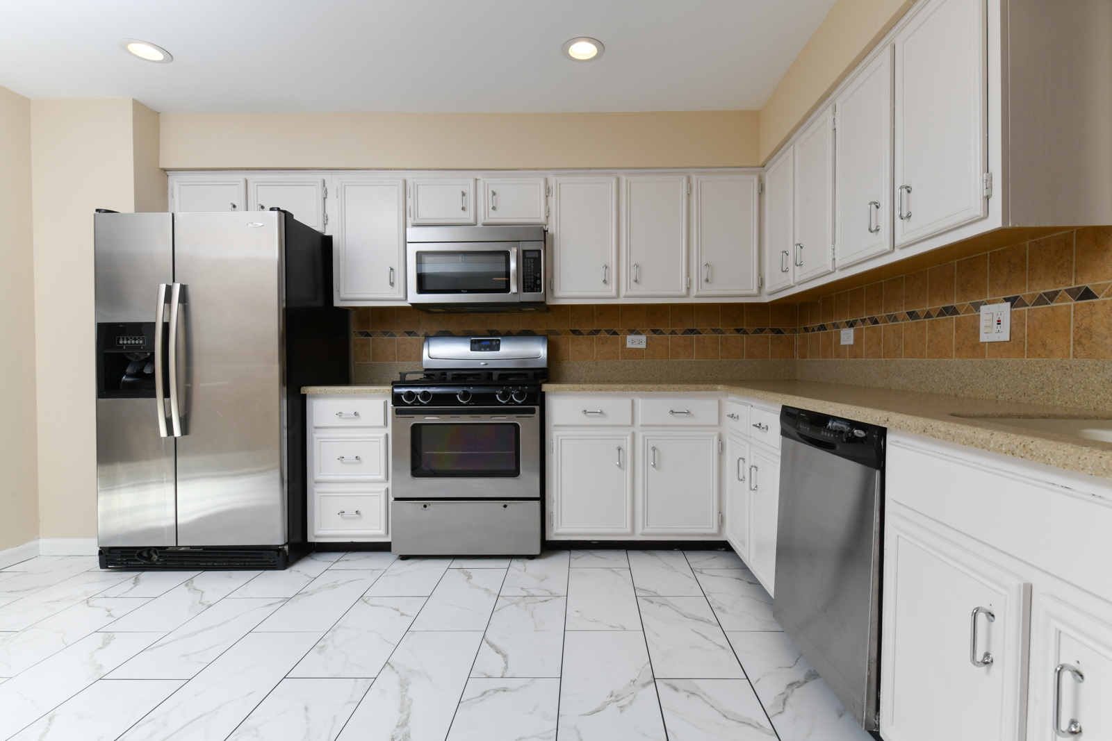 310 Dancing Water Court Carol Stream, IL 60188 - Photo 8 of 26 a kitchen with white cabinets and stainless steel appliances