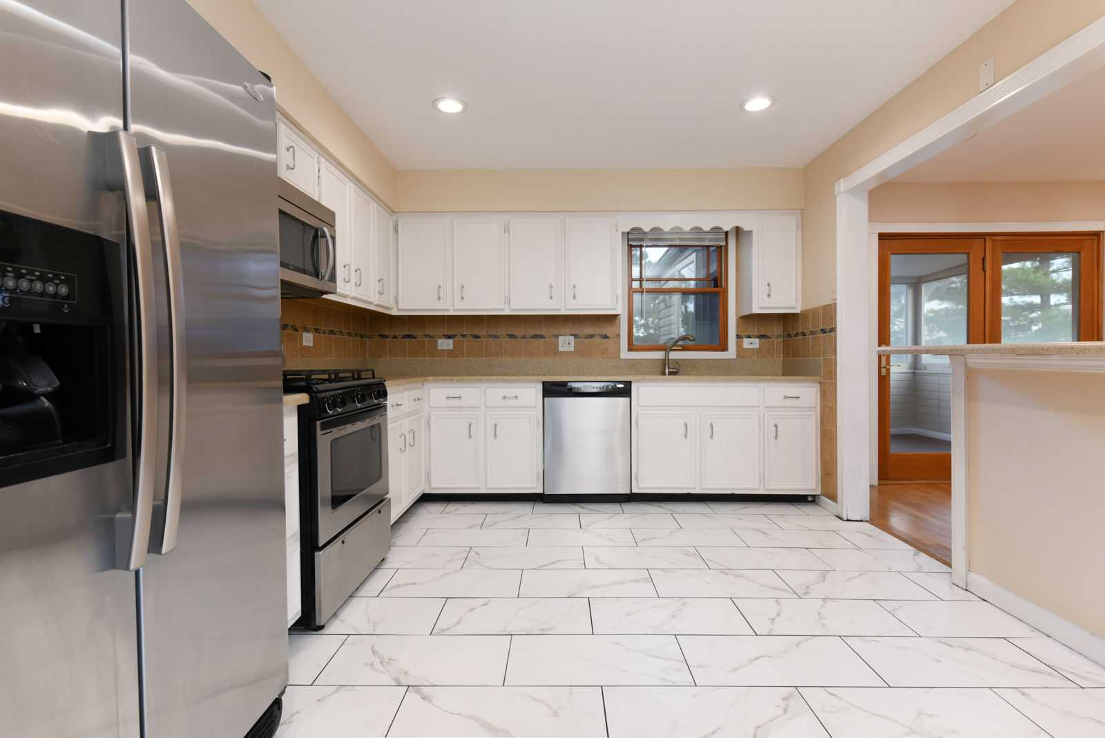 310 Dancing Water Court Carol Stream, IL 60188 - Photo 9 of 26 a kitchen with a stove a sink and a refrigerator