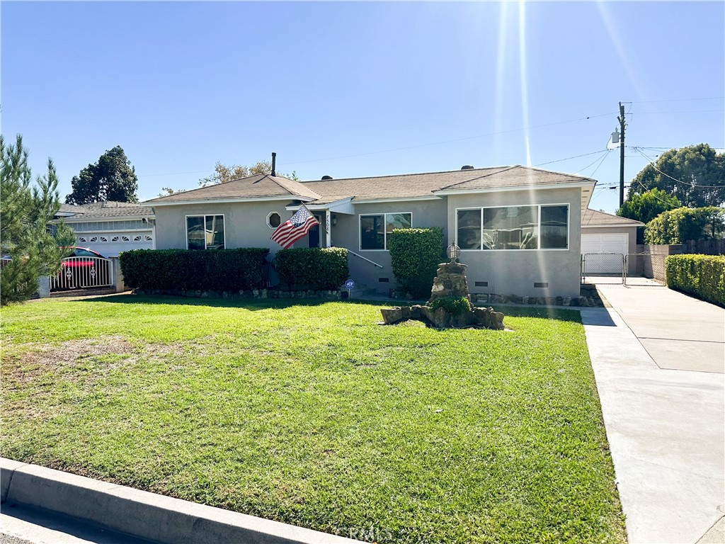 7508 Brookmill Road Downey, CA 90241 - Photo 1 of 20 a front view of a house with garden