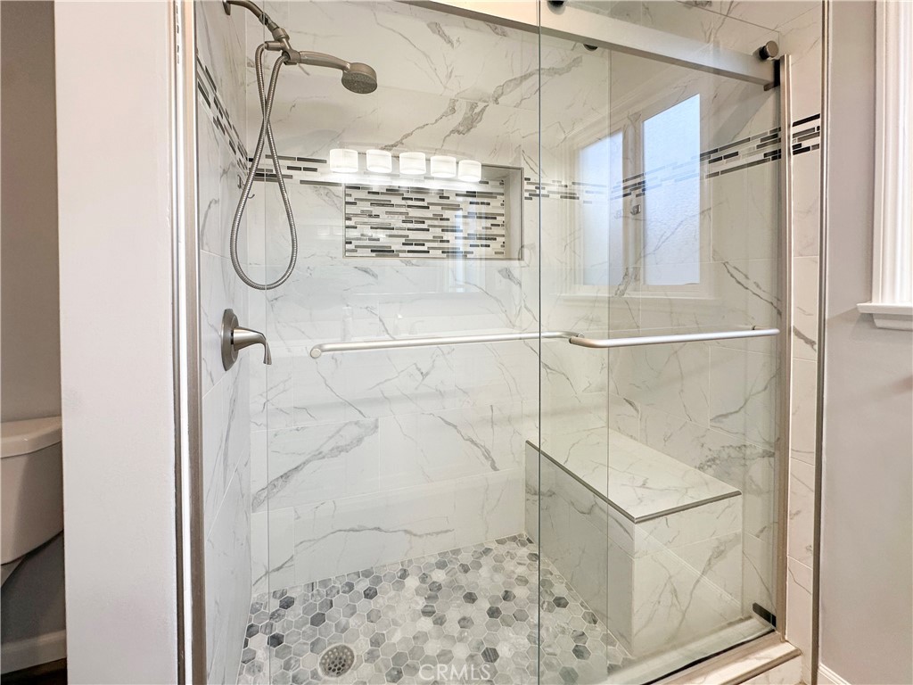 7508 Brookmill Road Downey, CA 90241 - Photo 13 of 20 a bathroom with a glass shower door