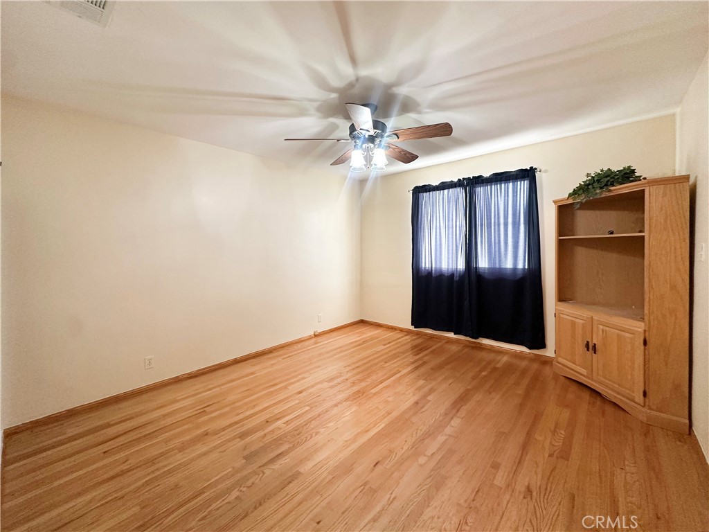 7508 Brookmill Road Downey, CA 90241 - Photo 15 of 20 wooden floor in an empty room with a window