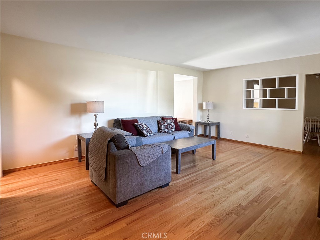 7508 Brookmill Road Downey, CA 90241 - Photo 2 of 20 a living room with furniture and a wooden floor