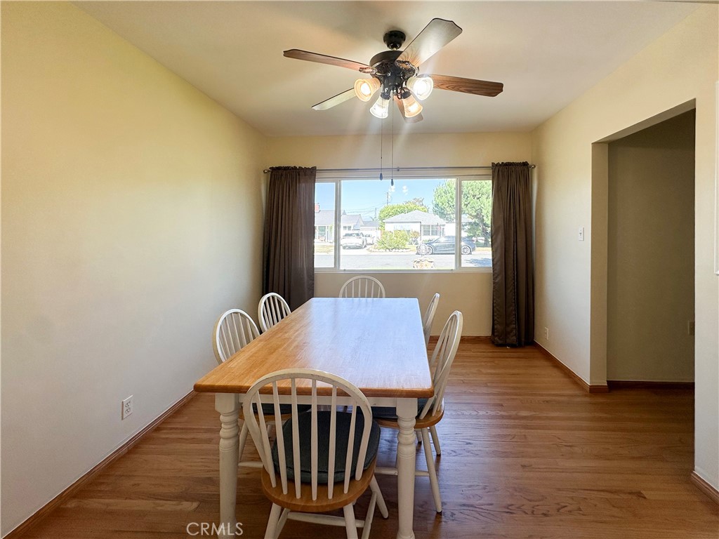 7508 Brookmill Road Downey, CA 90241 - Photo 7 of 20 a view of a dining room with furniture a chandelier and wooden floor