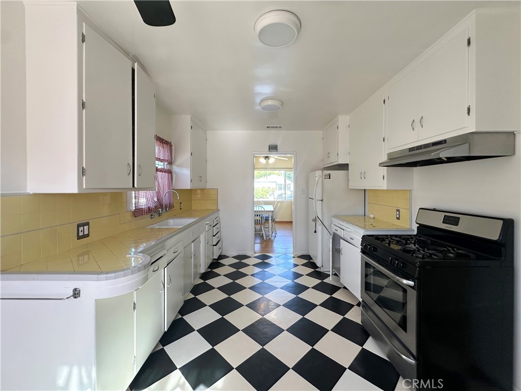 7508 Brookmill Road Downey, CA 90241 - Photo 8 of 20 a kitchen with a sink a stove and refrigerator