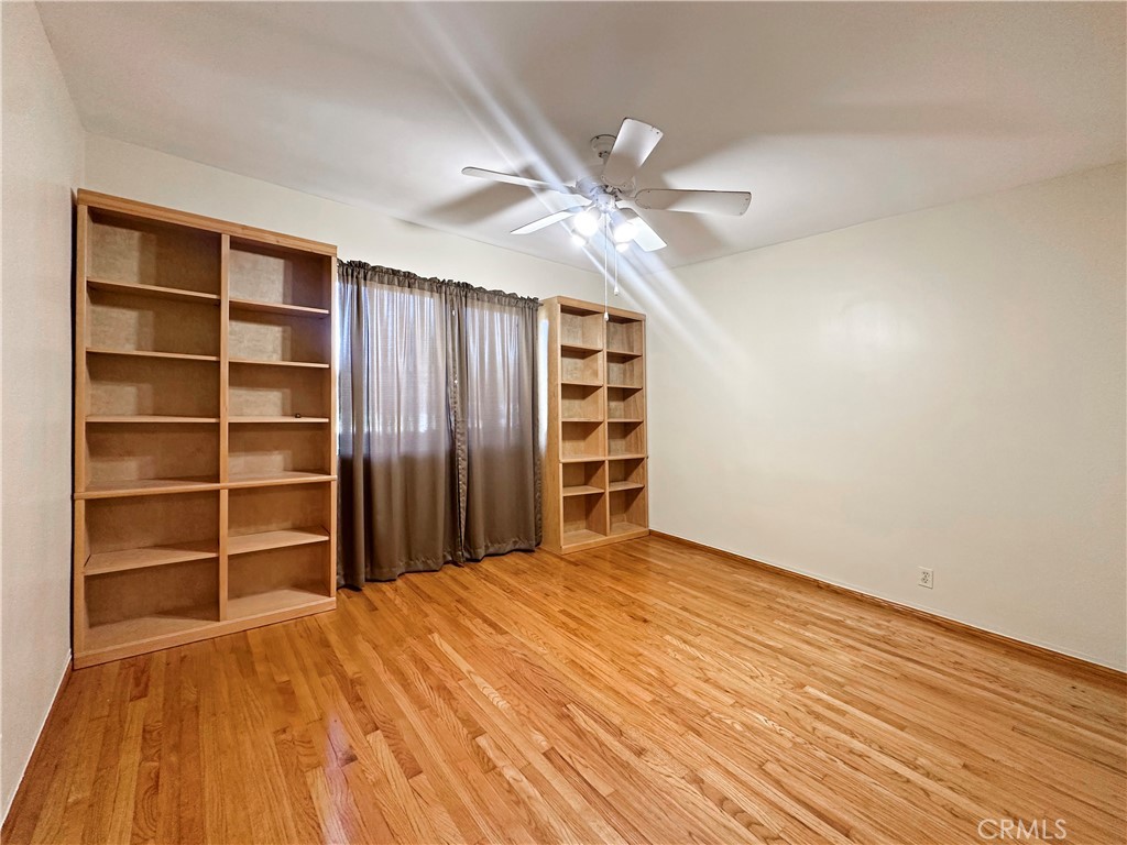 7508 Brookmill Road Downey, CA 90241 - Photo 10 of 20 a view of an empty room with a window and wooden floor