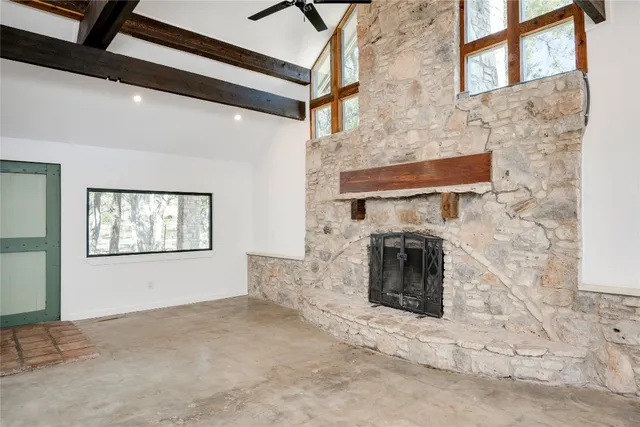 a view of a livingroom with a fireplace and window