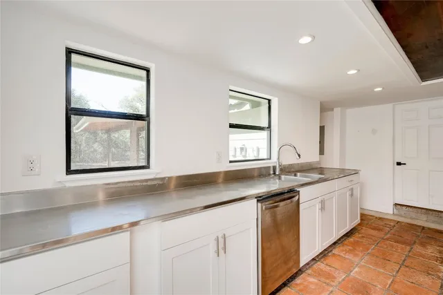 a kitchen with a refrigerator and a sink