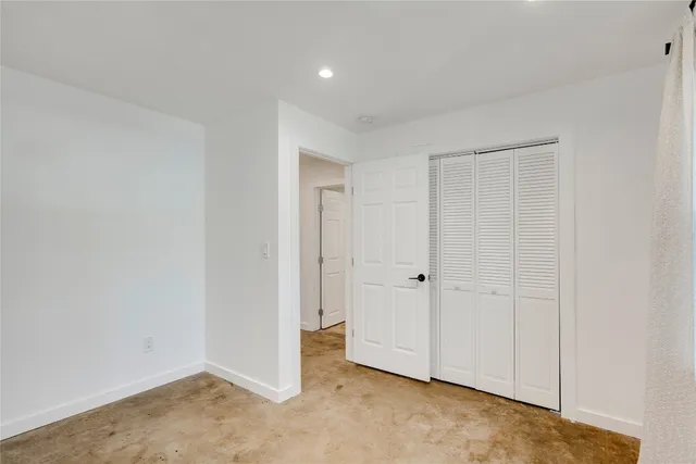 a view of a livingroom with an empty space and a window