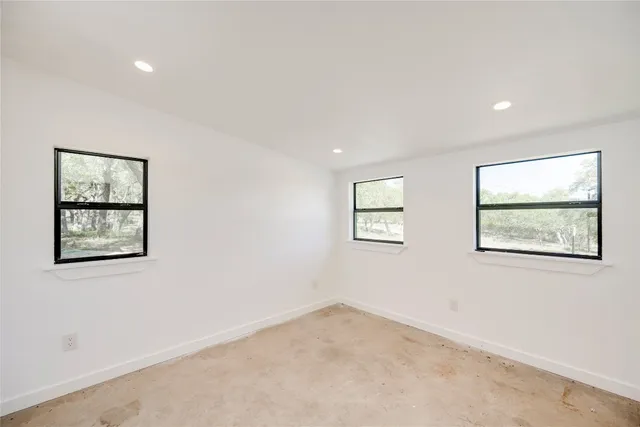 a view of a hallway with a white cabinet and a refrigerator