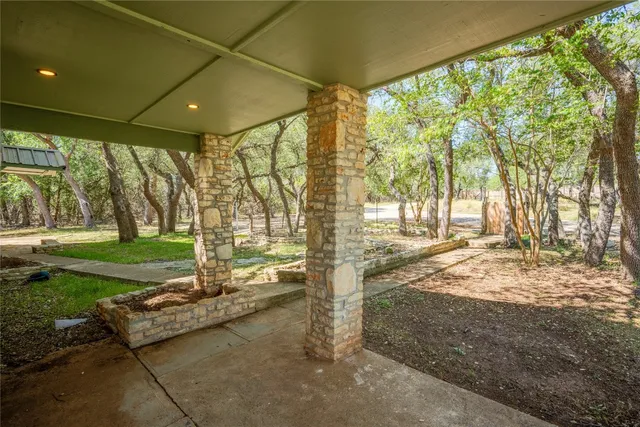 a backyard of a house with a garden and outdoor seating
