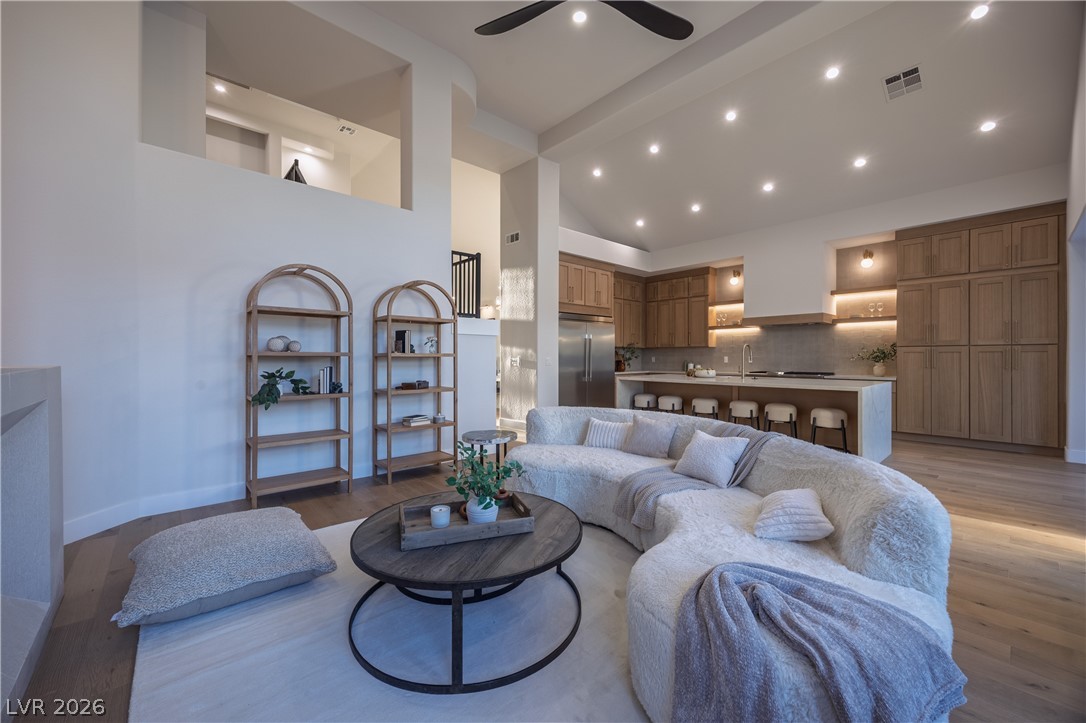 8800 Lusso Las Vegas, NV 89134 - Photo 27 of 85 Living room with vaulted ceiling, ceiling fan, light wood-style floors, and recessed lighting