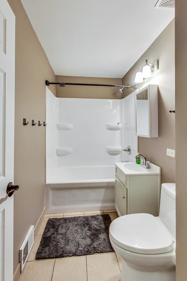 1216 Olive Road Homewood, IL 60430 - Photo 24 of 40 a bathroom with a toilet and a shower