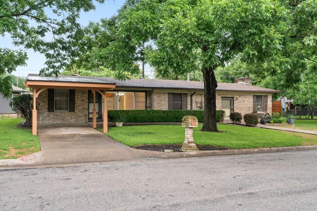 7601 Robalo Road Austin, TX 78757 - Photo 1 of 1 a front view of a house with a yard and a garage