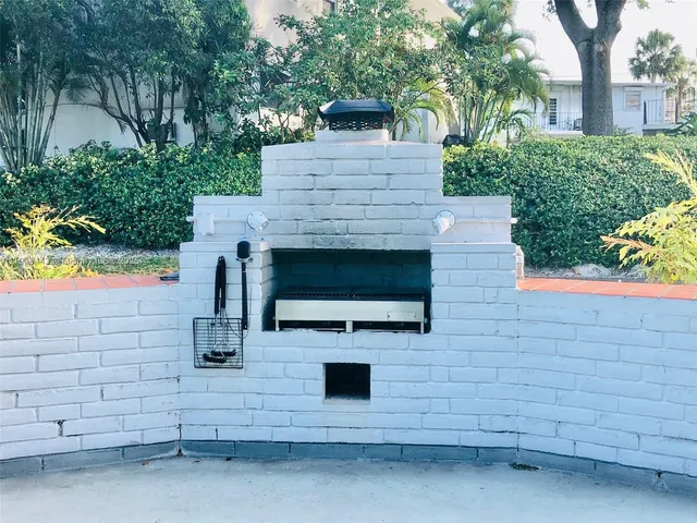 a stone house with potted plants in front of it