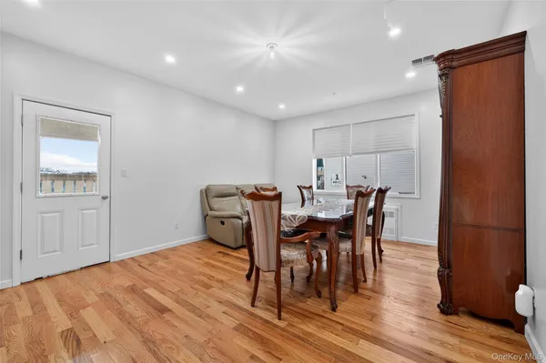 a dining room with furniture and wooden floor