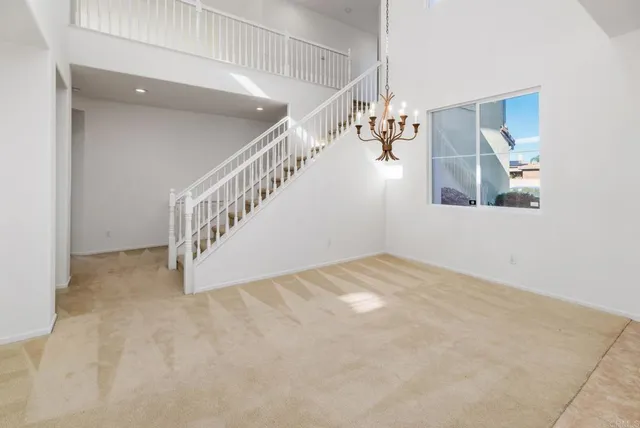 a view of an empty room with a kitchen