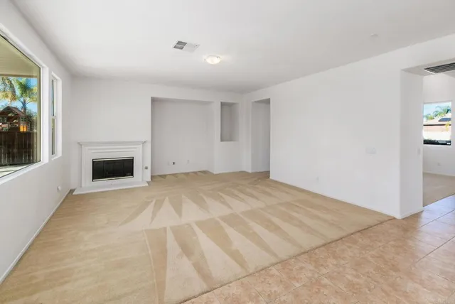 a large kitchen with kitchen island a large counter top stainless steel appliances and cabinets