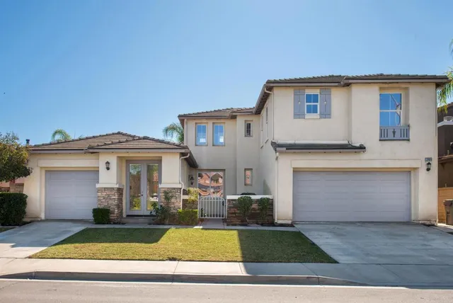 a living room with furniture a clock and a fireplace
