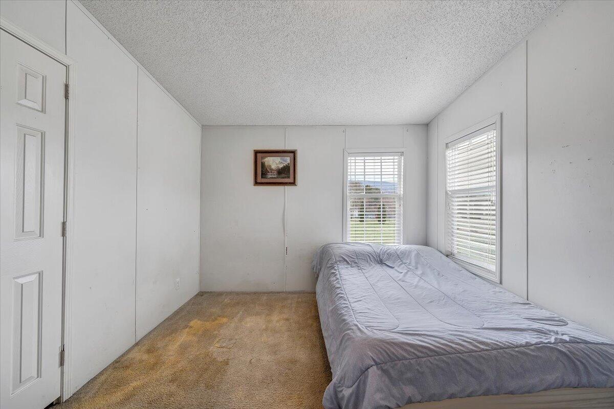 91 Homestead Road New Castle, VA 24127 - Photo 30 of 44 a bed sitting in a spacious bedroom next to a window