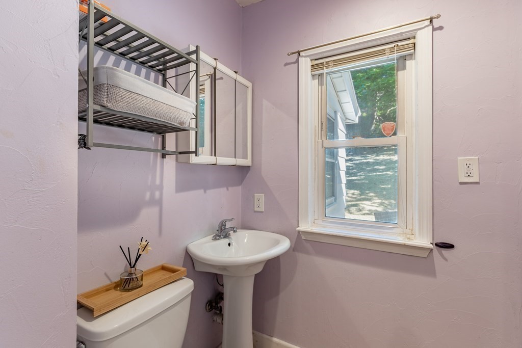 175 Hamilton Street Worcester, MA 01604 - Photo 8 of 21 a bathroom with a sink mirror toilet and window