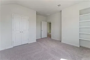 a view of an empty room and closet area