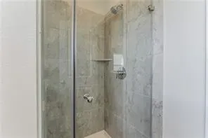 a bathroom with a shower and a toilet