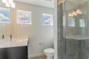 15107 Ryman Road Pflugerville, TX 78660 - Photo 23 of 34 a bathroom with a sink a toilet and shower