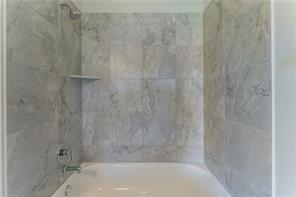 15107 Ryman Road Pflugerville, TX 78660 - Photo 30 of 34 a bathroom with a bathtub