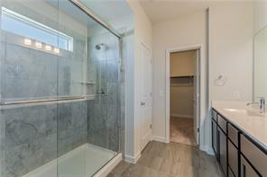15107 Ryman Road Pflugerville, TX 78660 - Photo 9 of 34 a bathroom with a shower and a sink