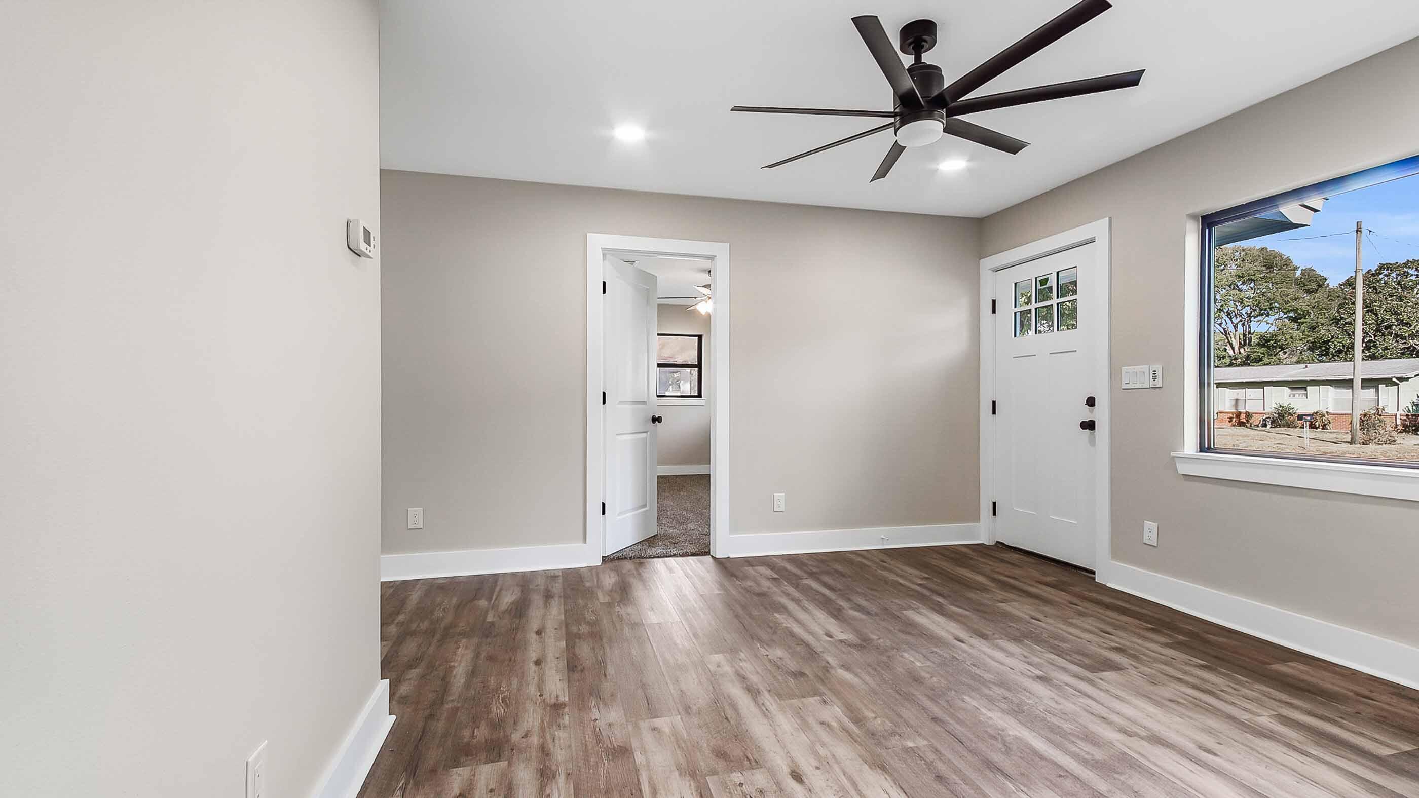 415 Avon Lane Mary Esther, FL 32569 - Photo 15 of 40 an empty room with wooden floor and windows