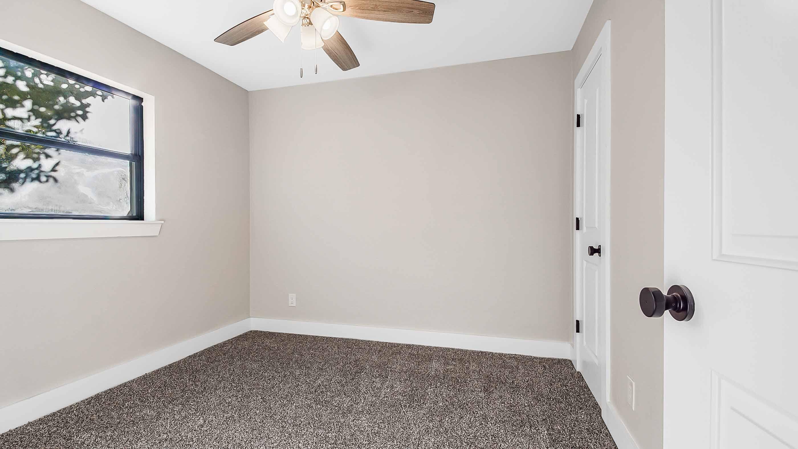 415 Avon Lane Mary Esther, FL 32569 - Photo 23 of 40 an empty room with a window and a ceiling fan