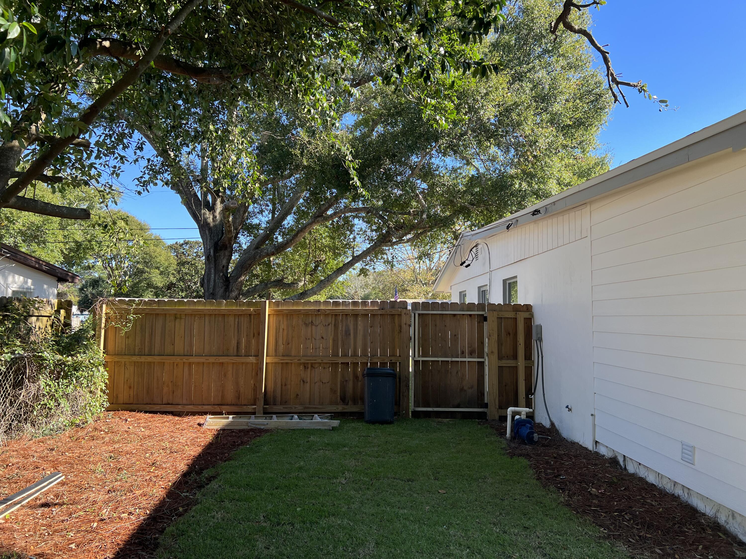 415 Avon Lane Mary Esther, FL 32569 - Photo 34 of 40 a backyard of a house with lots of green space
