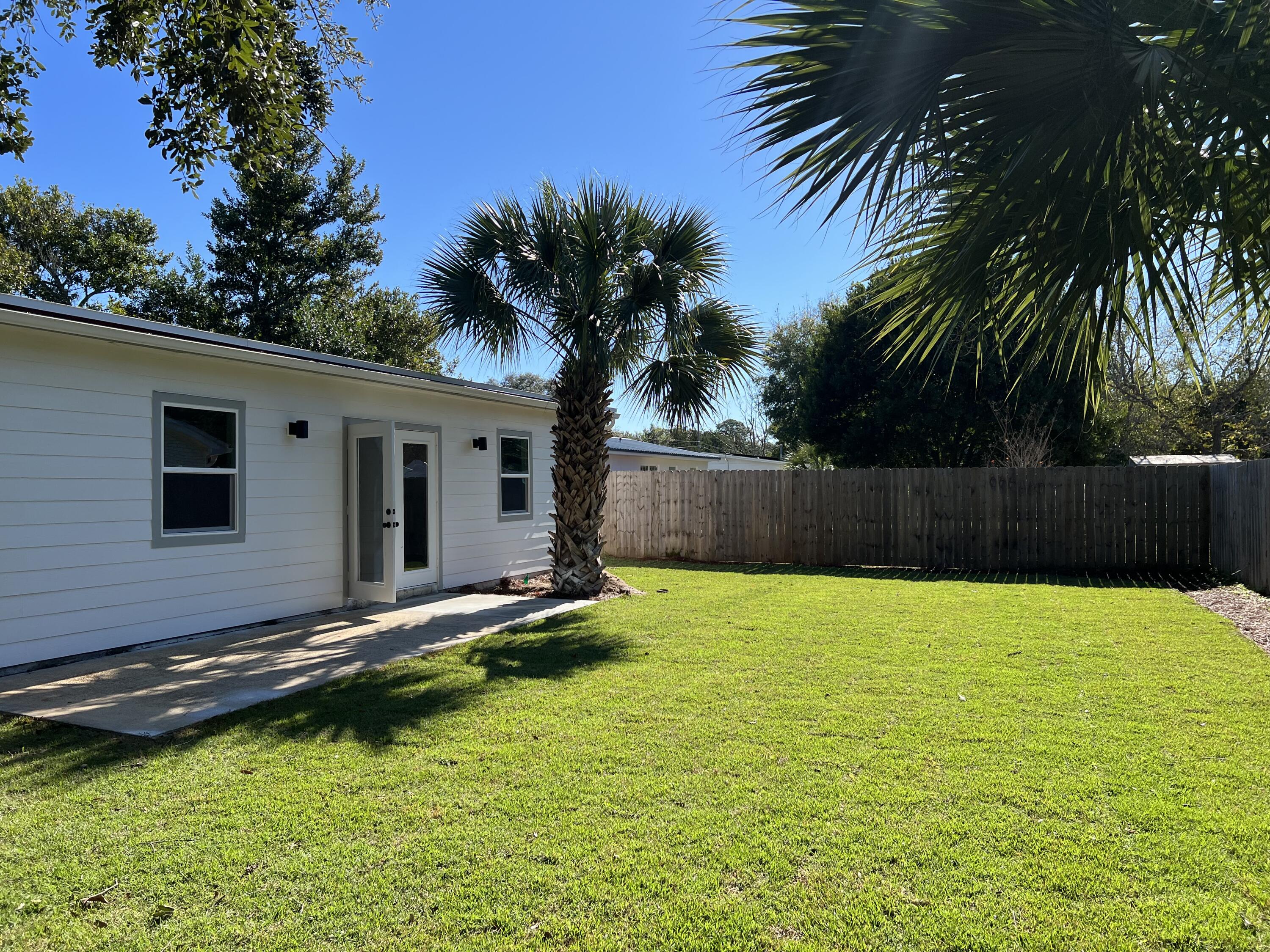 415 Avon Lane Mary Esther, FL 32569 - Photo 35 of 40 a backyard of a house with lots of green space