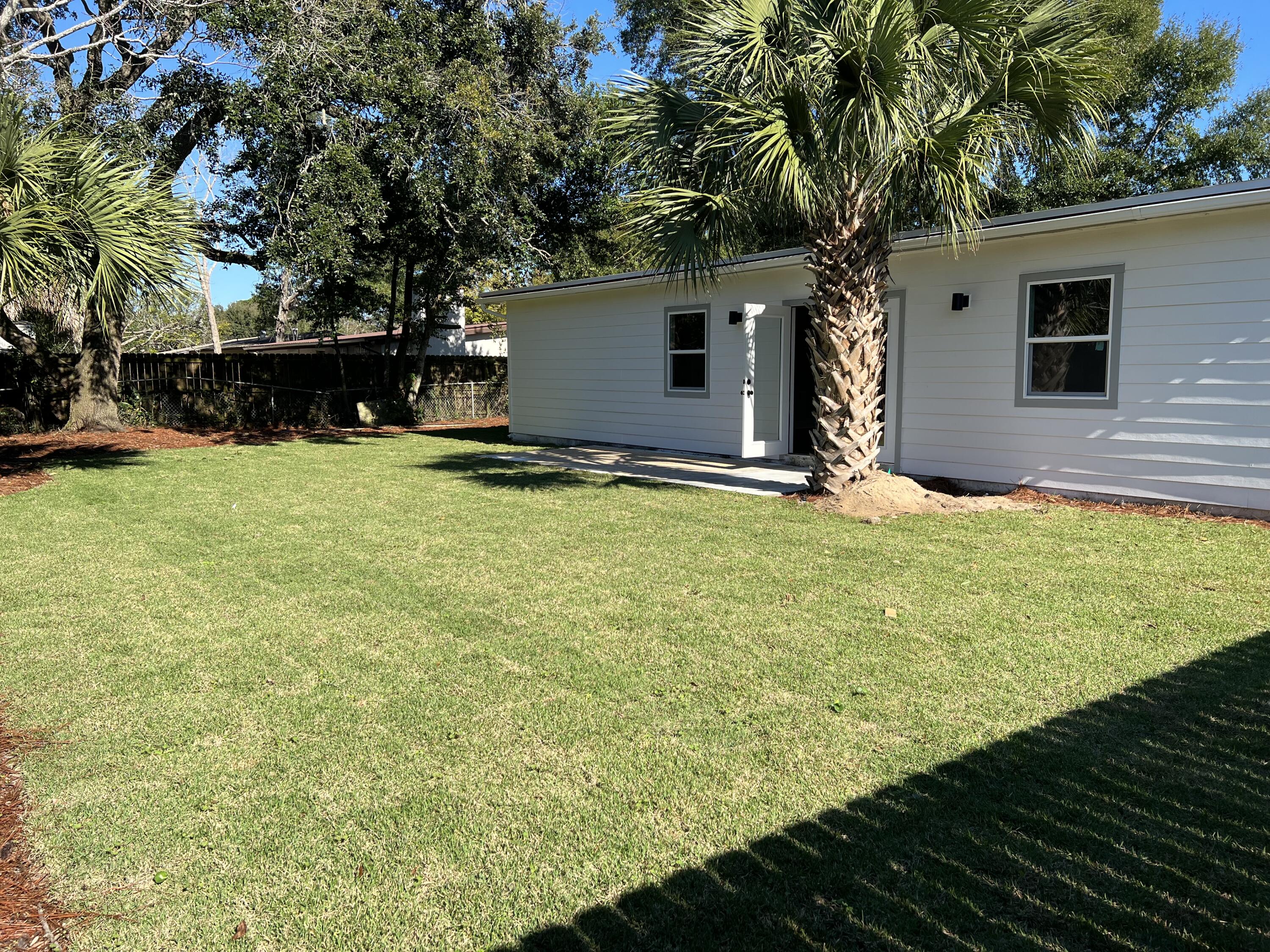 415 Avon Lane Mary Esther, FL 32569 - Photo 40 of 40 a backyard of a house with yard and garage