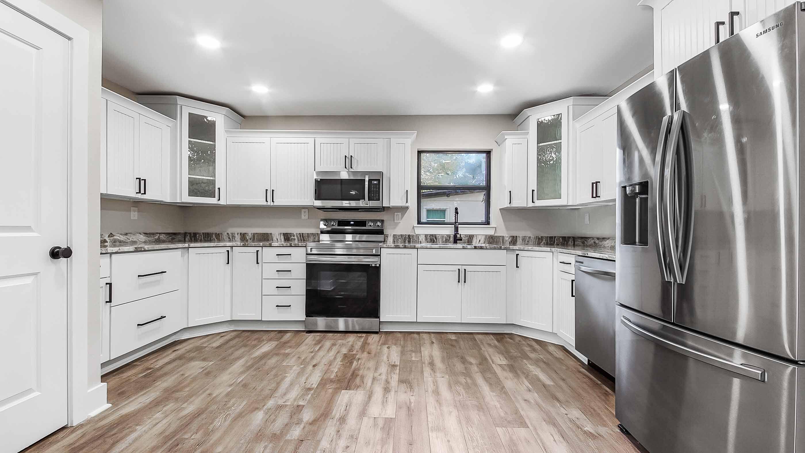 415 Avon Lane Mary Esther, FL 32569 - Photo 5 of 40 a kitchen with white cabinets stainless steel appliances and a window