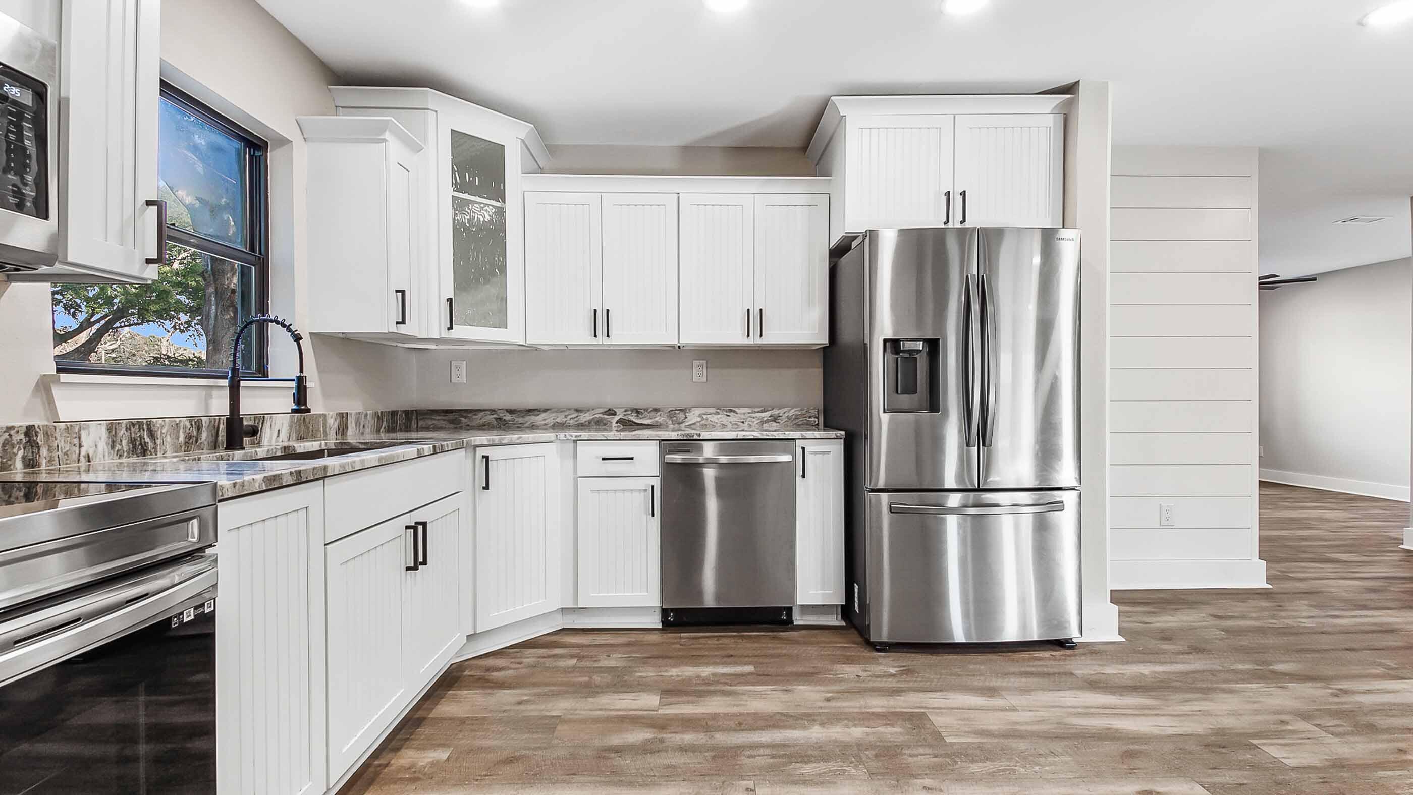 415 Avon Lane Mary Esther, FL 32569 - Photo 7 of 40 a kitchen with granite countertop a refrigerator stove and sink