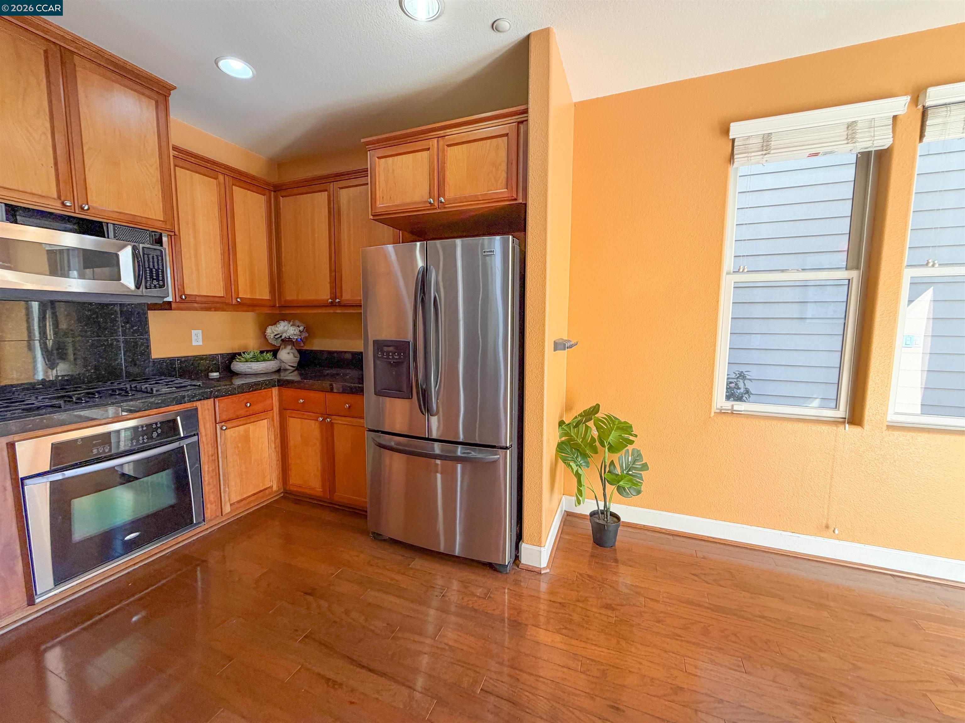 3198 South Front Street Hercules, CA 94547 - Photo 17 of 33 a kitchen with granite countertop stainless steel appliances a refrigerator cabinets and a window