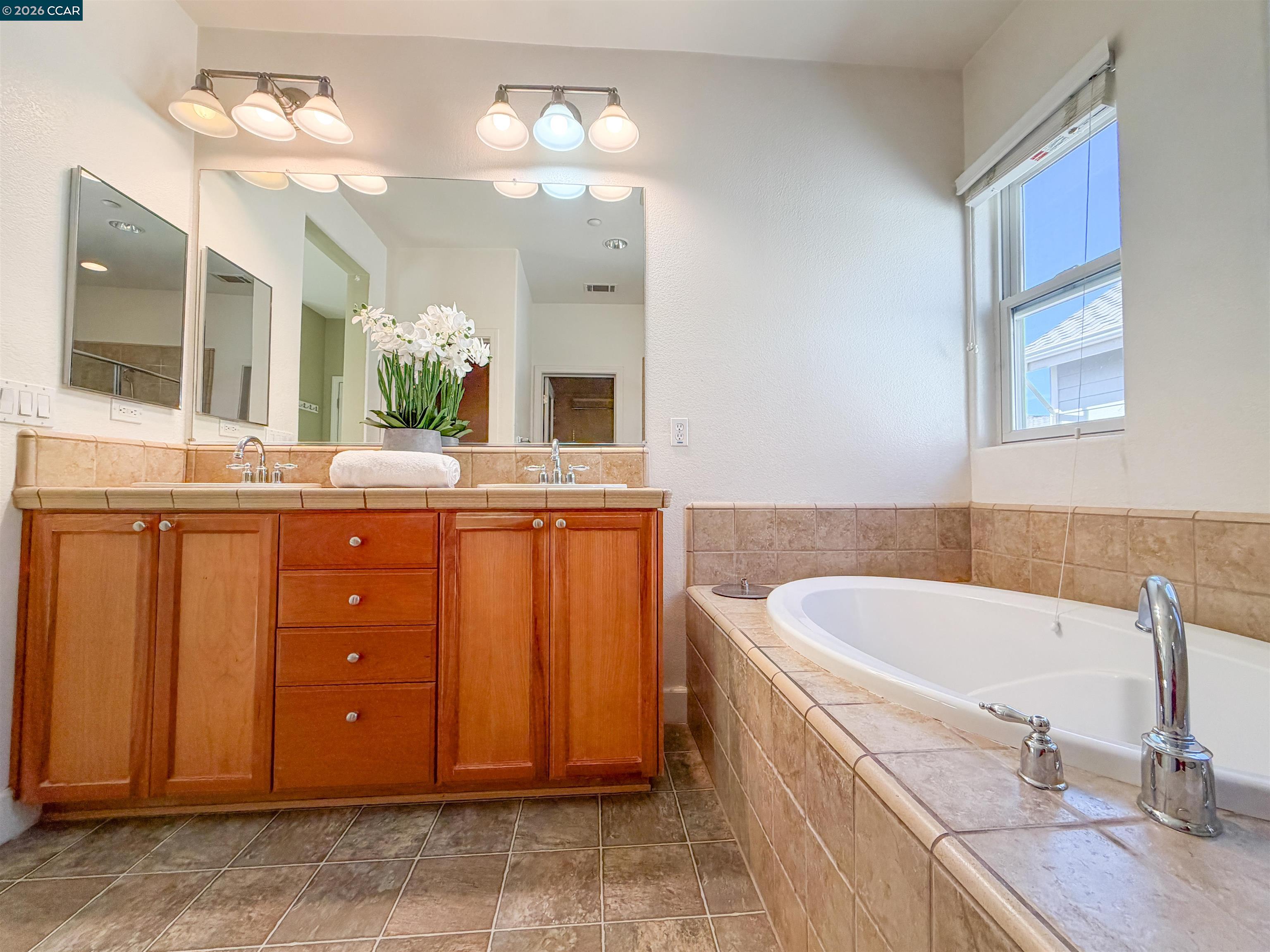 3198 South Front Street Hercules, CA 94547 - Photo 25 of 33 a bathroom with a granite countertop sink a large mirror and a bathtub