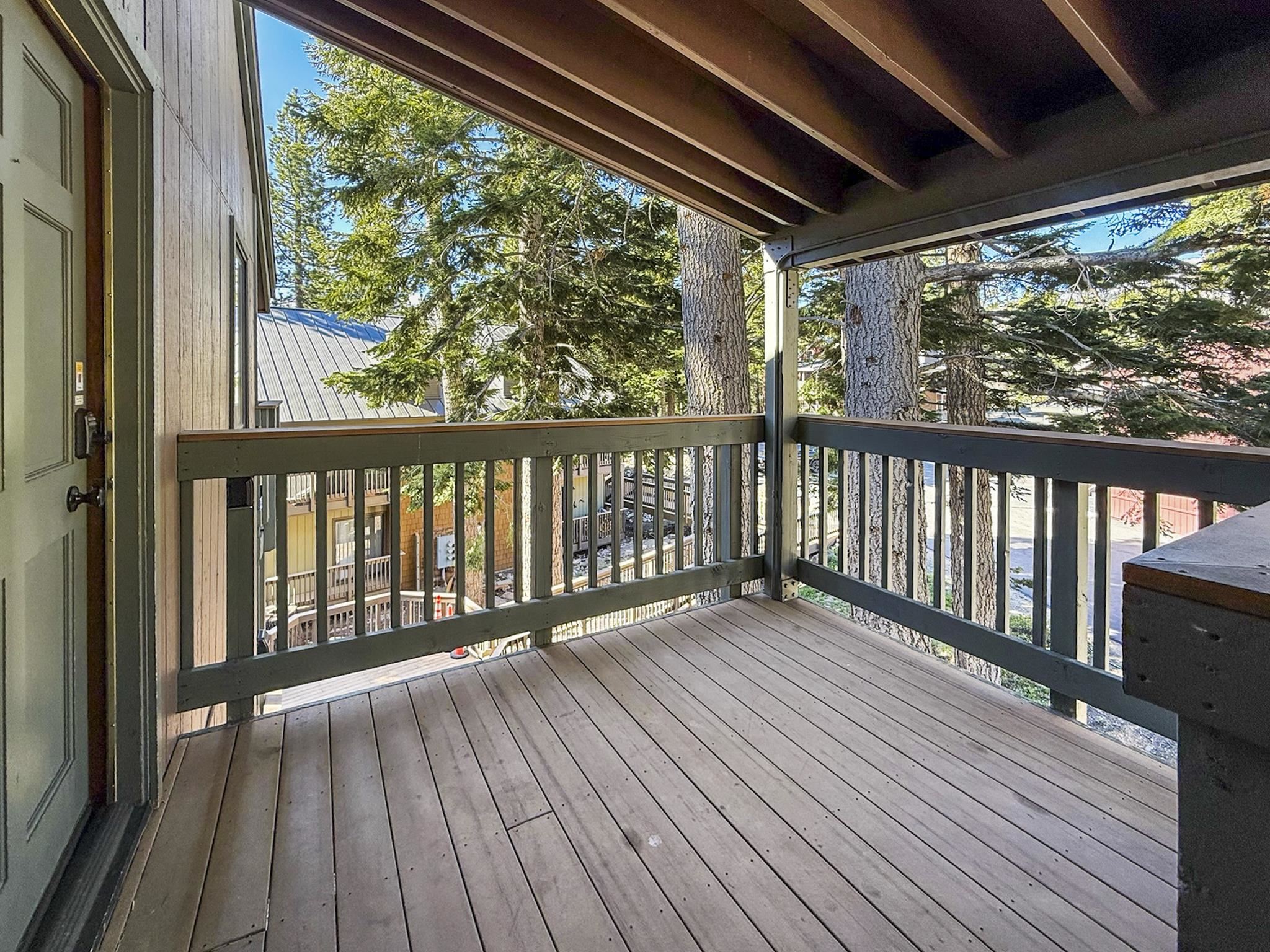 153 Lake Mary Road, Unit 114 Mammoth Lakes, CA 93546 - Photo 18 of 22 Spacious outdoor deck featuring natural wood flooring and a sturdy railing