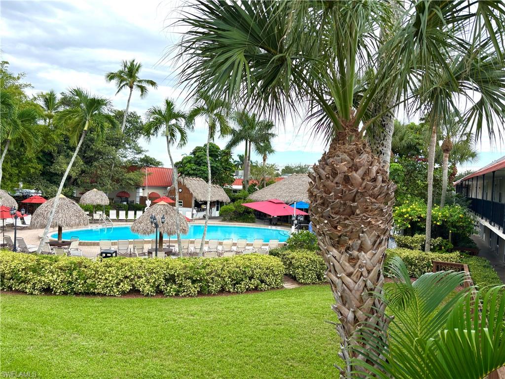 Community pool with a lawn and a patio area