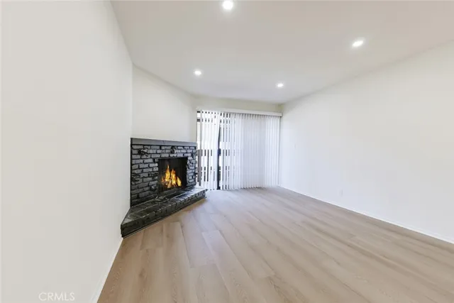 a view of an empty room with a fireplace