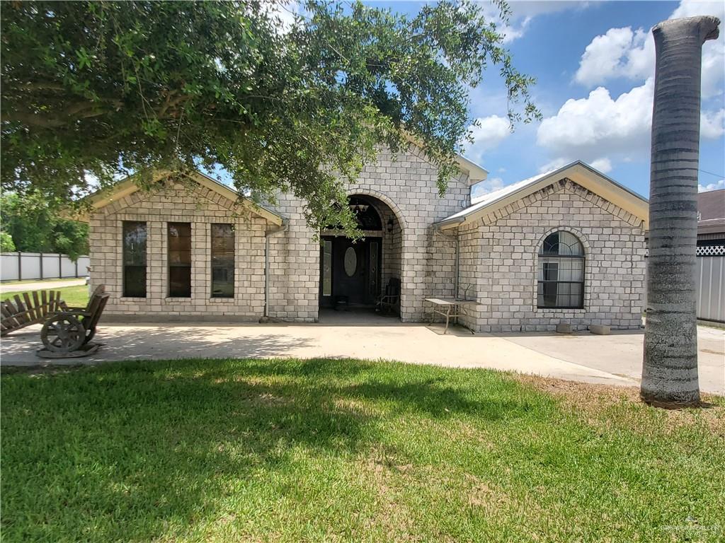 335 Watts Avenue Progreso, TX 78596 - Photo 1 of 1 a front view of a house with a garden and yard
