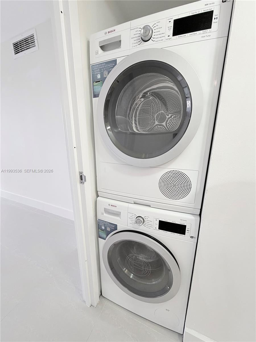2333 Brickell Avenue, Unit 1407 Miami, FL 33129 - Photo 22 of 38 a utility room with dryer and washer