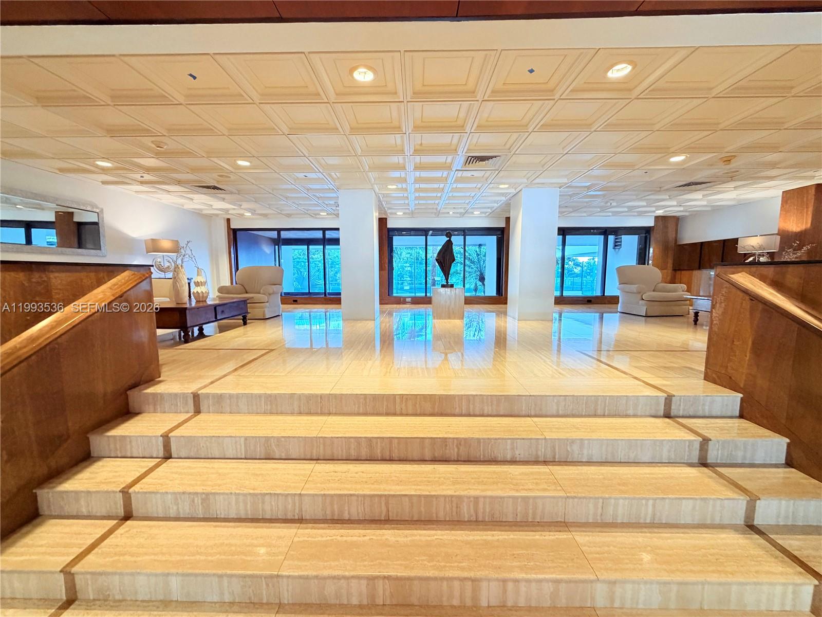 2333 Brickell Avenue, Unit 1407 Miami, FL 33129 - Photo 31 of 38 a living room with furniture and a chandelier