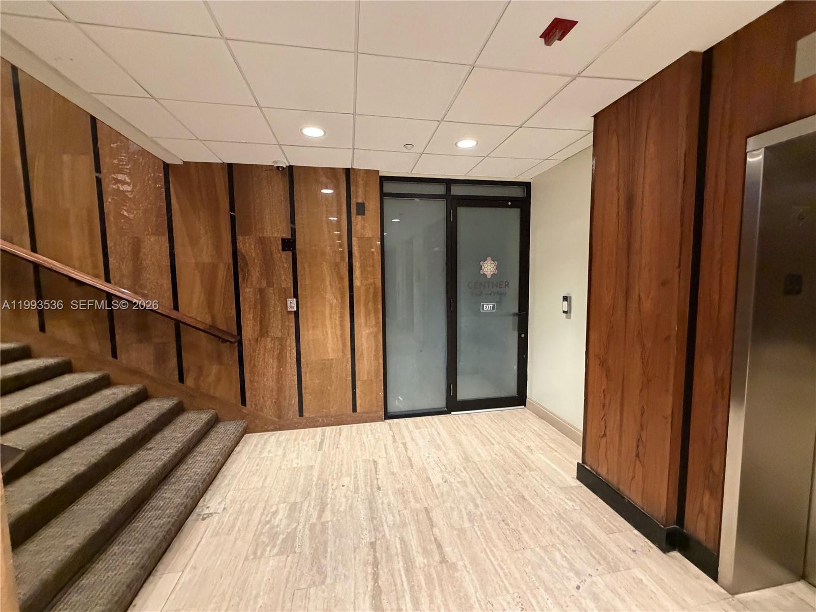 2333 Brickell Avenue, Unit 1407 Miami, FL 33129 - Photo 32 of 38 a view of a hallway with wooden floor and staircase