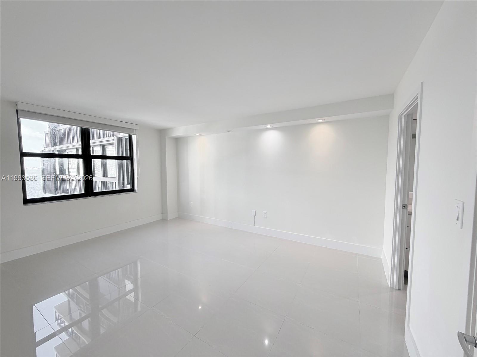 2333 Brickell Avenue, Unit 1407 Miami, FL 33129 - Photo 9 of 38 a view of an empty room with a window and cabinet