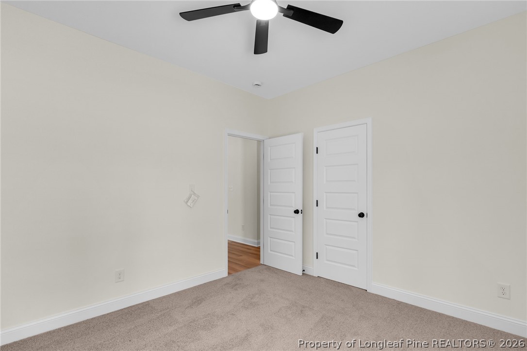 131 Merle Road Pinebluff, NC 28373 - Photo 27 of 33 an empty room with a ceiling fan and window
