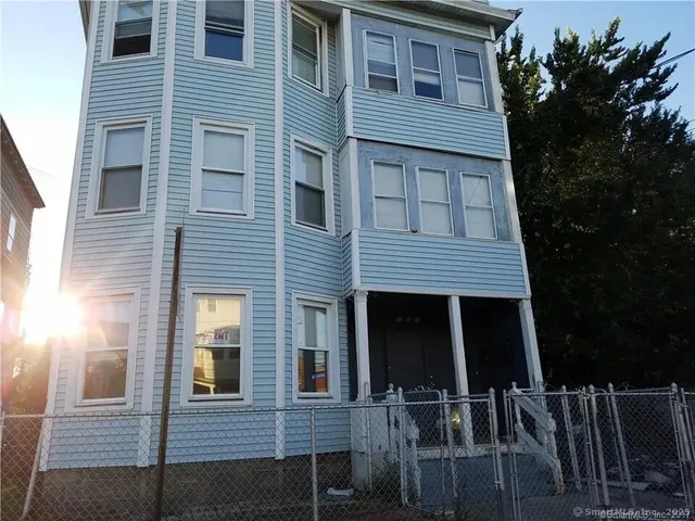 a front view of a house with plants