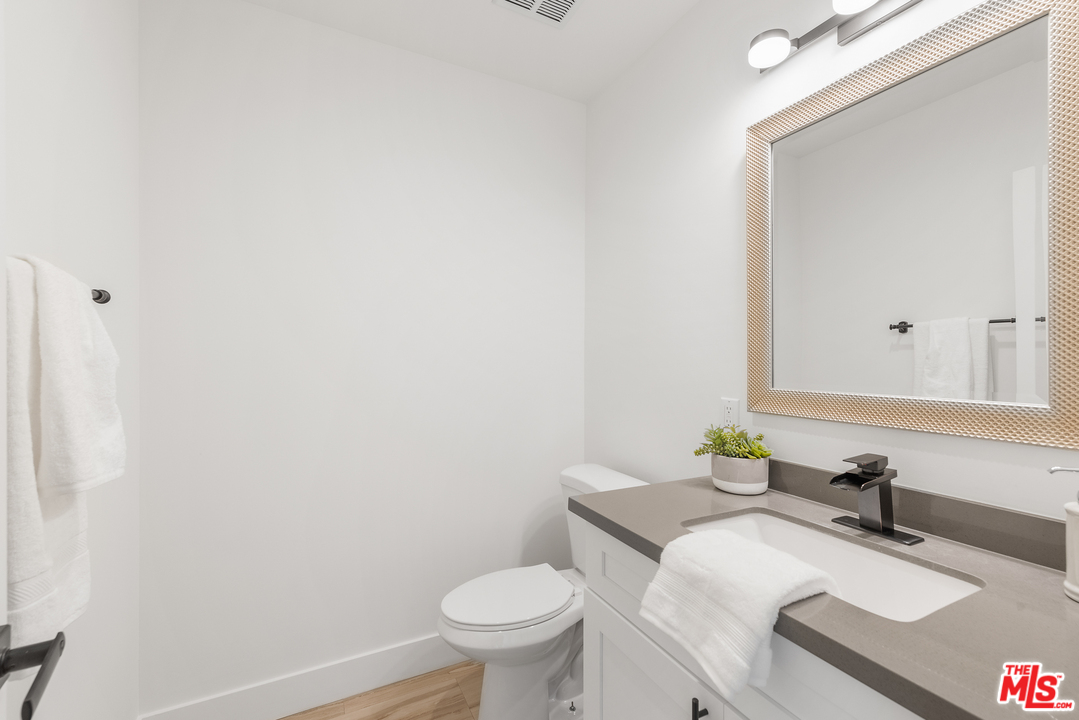 2223 North Keystone Street Burbank, CA 91504 - Photo 12 of 17 a bathroom with a granite countertop sink and a toilet
