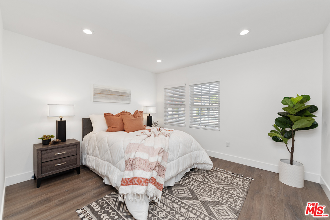 2223 North Keystone Street Burbank, CA 91504 - Photo 8 of 17 a bed room with a bed and a potted plant